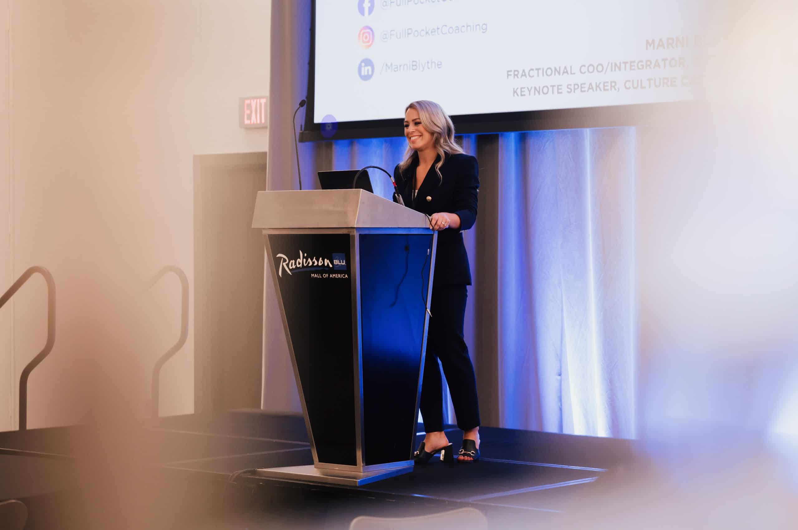 Dental keynote speaker Marni Blythe presenting on leadership and practice culture at a dental conference